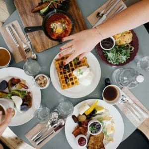 A table with brunch food on plates.