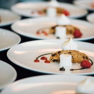 Multiple white plates with desserts on them