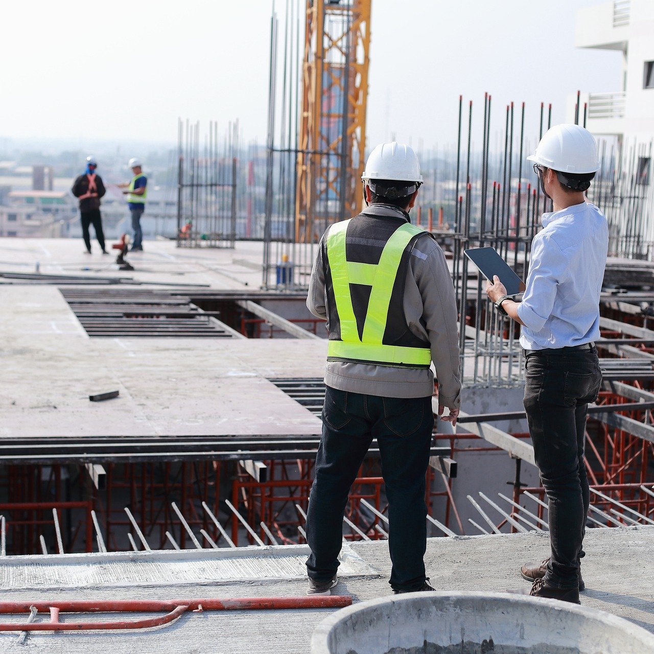 Two construction workers at a building site