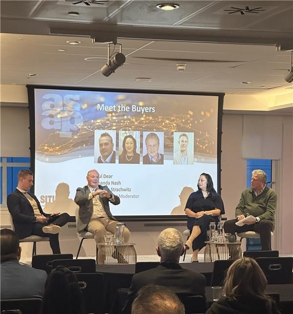 Photo of four professionals in front of a banner with the name of the session on it, 'Meet the Buyers' at the Association of Serviced Apartment Providers Annual Conference 2024